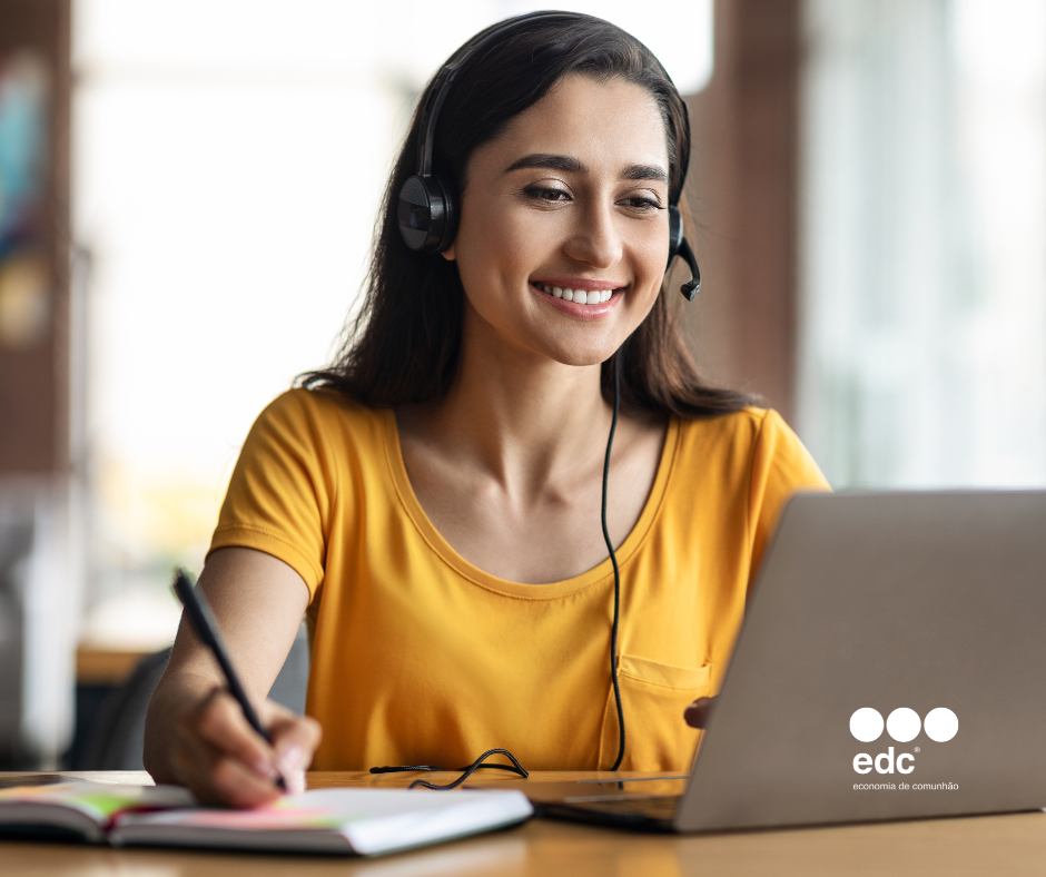 Grupo de jovens de diferentes etnias, vestindo roupas corporativas e sorrindo, com pastas e papéis nas mãos.